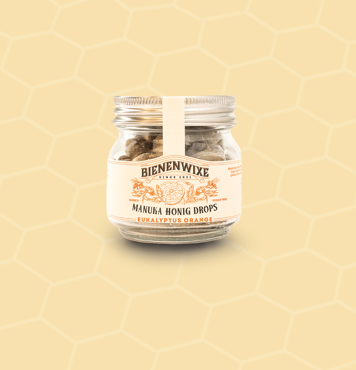 Bienenwixe Manuka Honig Drops mit Eukalyptus und Orange in einem Glasbehälter.